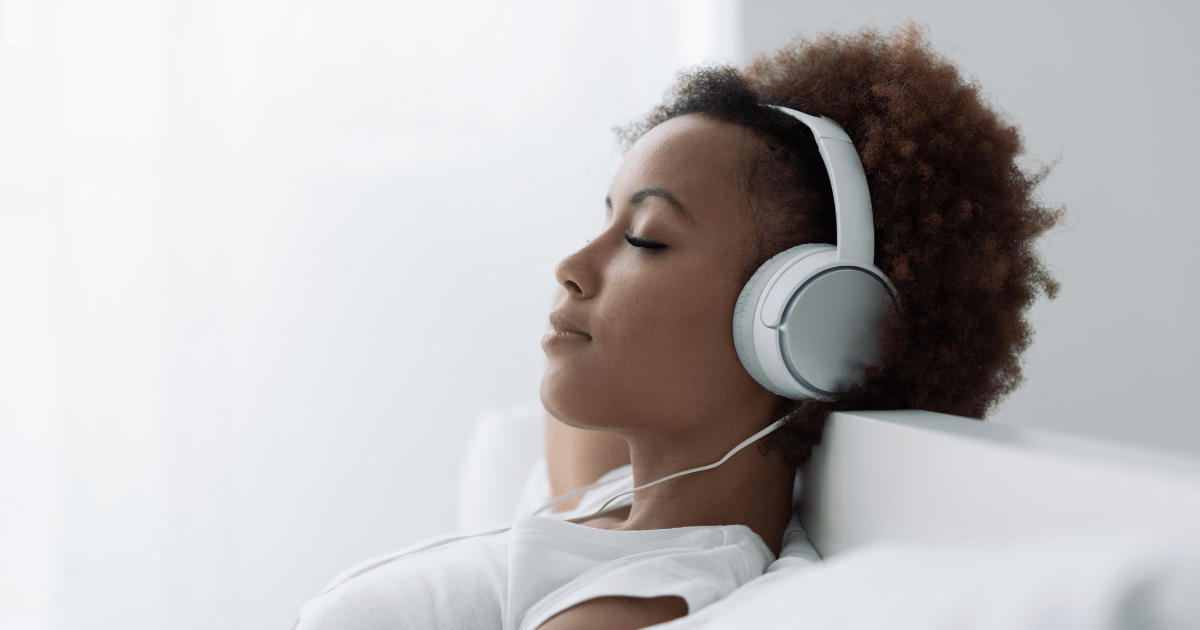 Parent relaxing with noise canceling headphones.